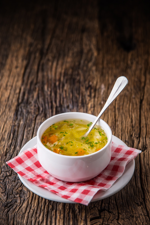 Chicken broth.Beef Broth. Bone broth with noodles carrot and parsley in white bowl.の写真素材