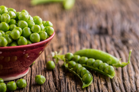 Peas. Fresh bio homemade peas and pods on old oak board. Healthy fresh green vegetable - peas and pods.の写真素材