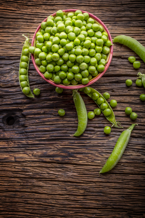 Peas. Fresh bio homemade peas and pods on old oak board. Healthy fresh green vegetable - peas and pods.の写真素材