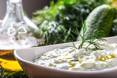 Tzatziki. Traditional greek dip sauce or dressing tzatziki prepared  with grated cucumber sour cream yogurt olive oil and fresh dill. Mediterranean cuisine.の写真素材