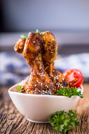 Grill chicken legs. Grilled chicken legs BBQ with sesame parsley and tomato.の写真素材