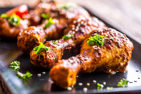 Grill chicken legs. Grilled chicken legs BBQ with sesame parsley and tomato.の写真素材