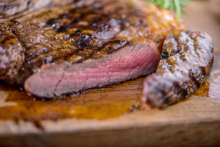 Grill juicy beef T-bone steak with salt pepper and rosemary.の写真素材