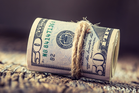 Dollars rolled banknotes closeup. Cash Money American Dollars.Close-up view of stack of US dollars.の写真素材