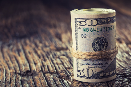 Dollars rolled banknotes closeup. Cash Money American Dollars.Close-up view of stack of US dollars.の写真素材