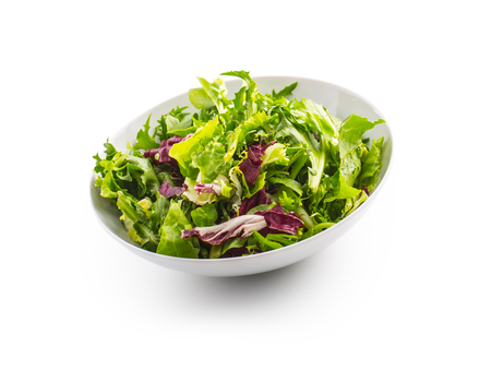 Salad Isolated on White. A bowl of fresh lettuce green salad over white with shadow.の写真素材