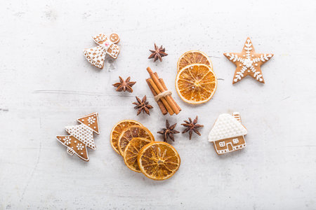 Cinnamon star anise gingerbread and dry orange on white concrete background. Top of view.