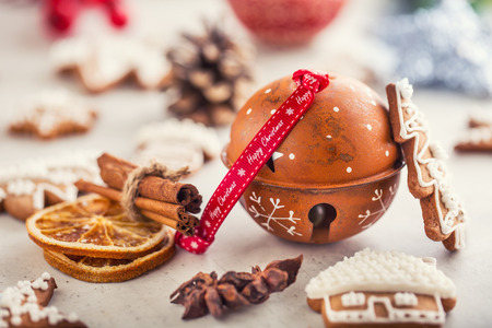 Jingle bell gingerbread cinnamon star anise on table.の写真素材