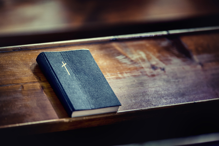 Book holy bible. Holy Bible on old wooden church table.の写真素材
