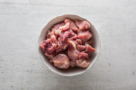 Pork raw slieced meat on white concrete board. Top of view.の写真素材