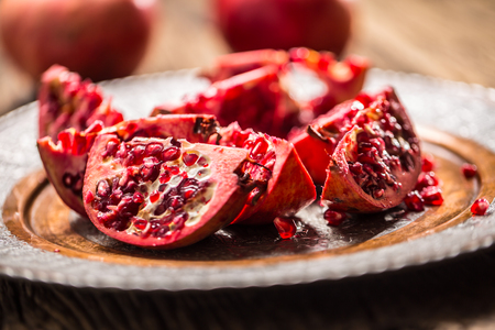 Pomegranate. Pieces of frest pomegranate on plate.の写真素材