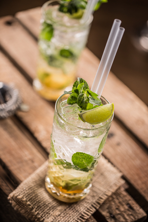 Mojito. Alcoholic cocktail drink mojito on wooden board in pub or sestaurant.の写真素材