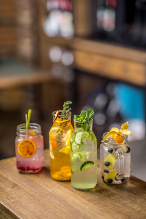 Lemonades. Lemonades with fresh tropical fruit and cucumber on bar counter in pub or restaurant.の写真素材