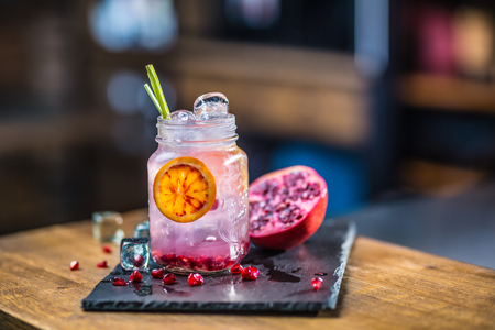Lemonade. Lemonade vith fresh fruit pomegranate on barcounter in pub or restaurant.の写真素材