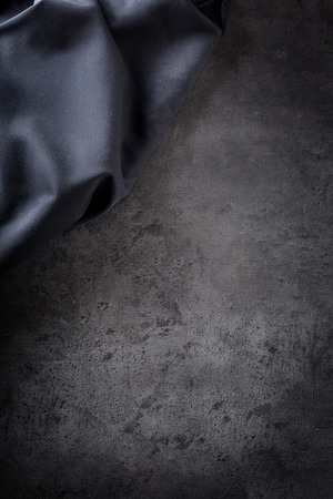 Black napkin tablecloth on black concrete board. の写真素材