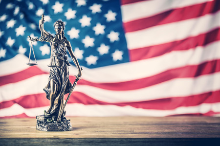 Lady Justice and American flag. Symbol of law and justice with USA Flag.の写真素材