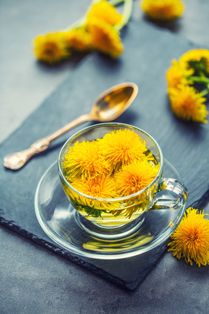 Cup of dandelion tea on slate board.の写真素材