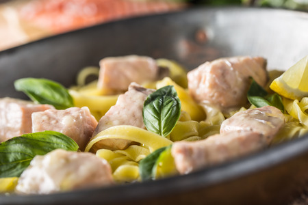 Pieces of salmon with pasta tagliatelle lemon and basil.の写真素材
