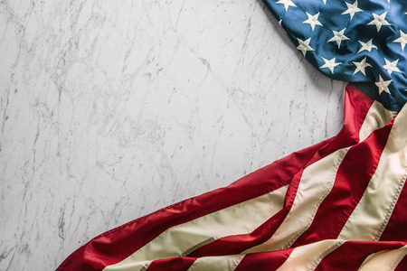 Close-up american flag on white marble background.の写真素材
