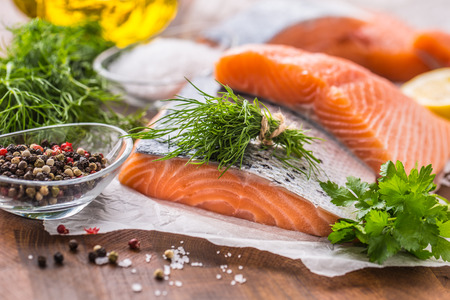 Raw salmon fillet with dill lemon olive oil salt and pepper.の写真素材