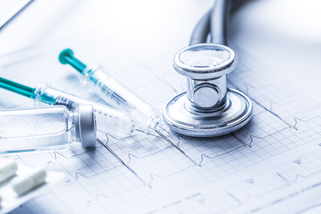 Stethoscope injections pills on the  EKG graph -  elektrokardiogram.の写真素材