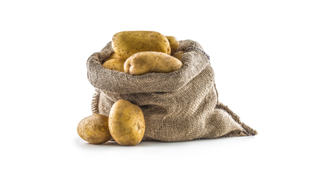 New potatoes in burlap sack isolated on white background.の写真素材
