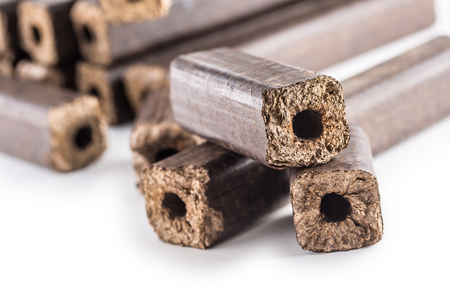 Wooden pressed briquettes Pini Kay from biomass on a white isolated background.の写真素材