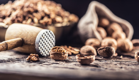 Walnut kernels whole walnuts in burlap sack and vintage bowl.の写真素材