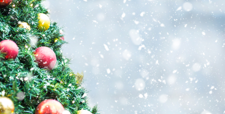 Christmas tree with balls lights in snowy atmosphere.の写真素材