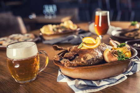 Roasted christmas duck red cabbage dumplings liver draft beer and baked buns.の写真素材