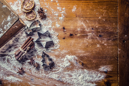 Top of view bakery table full of christmas aromatic ingredients star anise cinnamon dried orange...