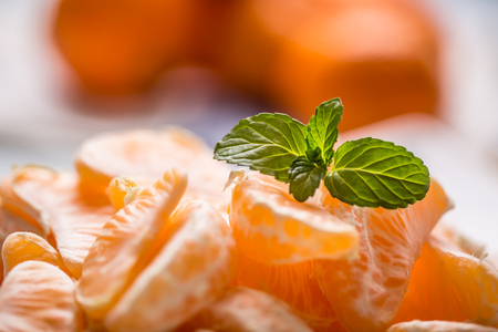 Fresh pieces of tangerines mandarin on the plate or in a bowl.の写真素材