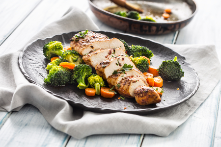 Roasted chicken breast with broccoli carrot and sesame.の写真素材