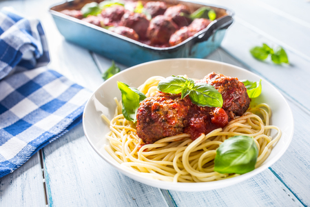 Delisious italian meal meat beef balls with pasta spaghetti and basil in white plate.の写真素材