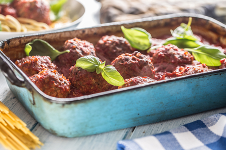 Delisious italian meal meat beef balls with pasta spaghetti and basil in vintage roaster pan.の写真素材