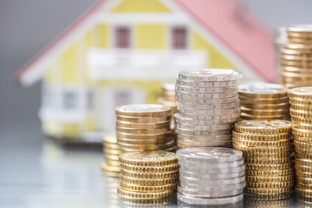 Model familly house with coins as bank or insurance concept.の写真素材