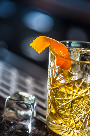 Cocktail drink old fashioned at barcounter in night club or restaurant.の写真素材