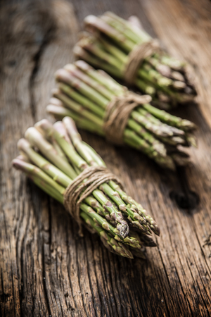 Fresh green asparagus on old oak table.の写真素材