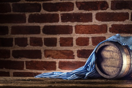 Oktoberfest wooden barrel and blue tablecloth on rustic oak table.の写真素材