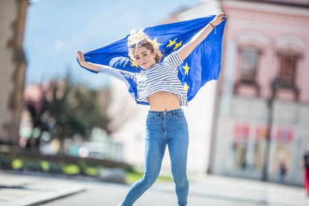 Attractive happy young girl with the flag of the European Union.の写真素材