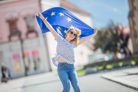 Attractive happy young girl with the flag of the European Union.の写真素材