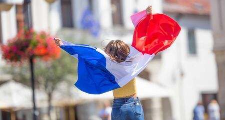 Attractive happy young girl with the France flag.の写真素材