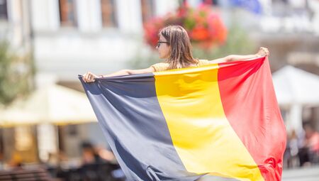 Attractive happy young girl with the Belgian flag.の素材 [FY310128858894]