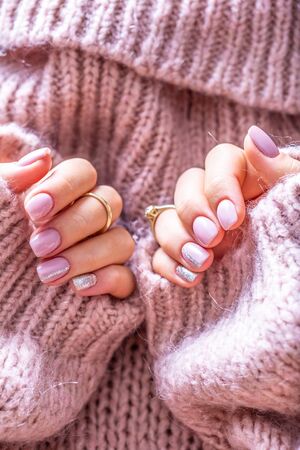 Art nail manicure for bride in purple sweater. Gel nails in soft pink color.の写真素材