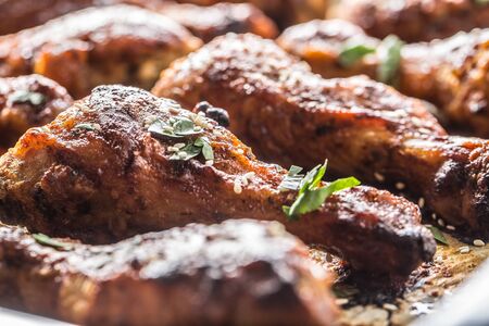 Roasted chicken legs barbecue on baked paper - Close-up.の写真素材