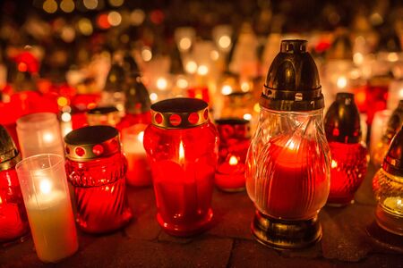 Many burning candles in the cemetery at night on the occasion souls of the deceased.の写真素材
