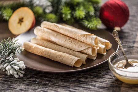 Wafers rolled with honey. Traditional slovak and czech christmas pastry - oblatky.の写真素材