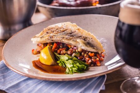 Fillet of zander with vegetables on a plate in a restaurant.の写真素材