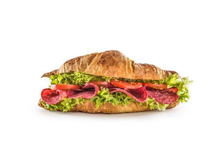 Croissant stuffed with lettuce salad salami and cheese isolated on white background.の写真素材