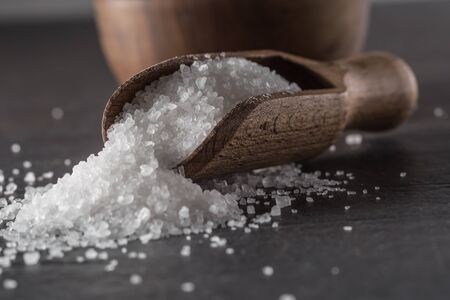 Crystaline sea salt in bowl and spoon - closeup.